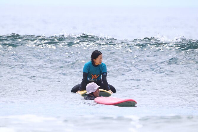 Group Surf Class in Playa de Las Américas with Photographs - Getting outfitted: wetsuit, booties, board, and the photo t-shirt